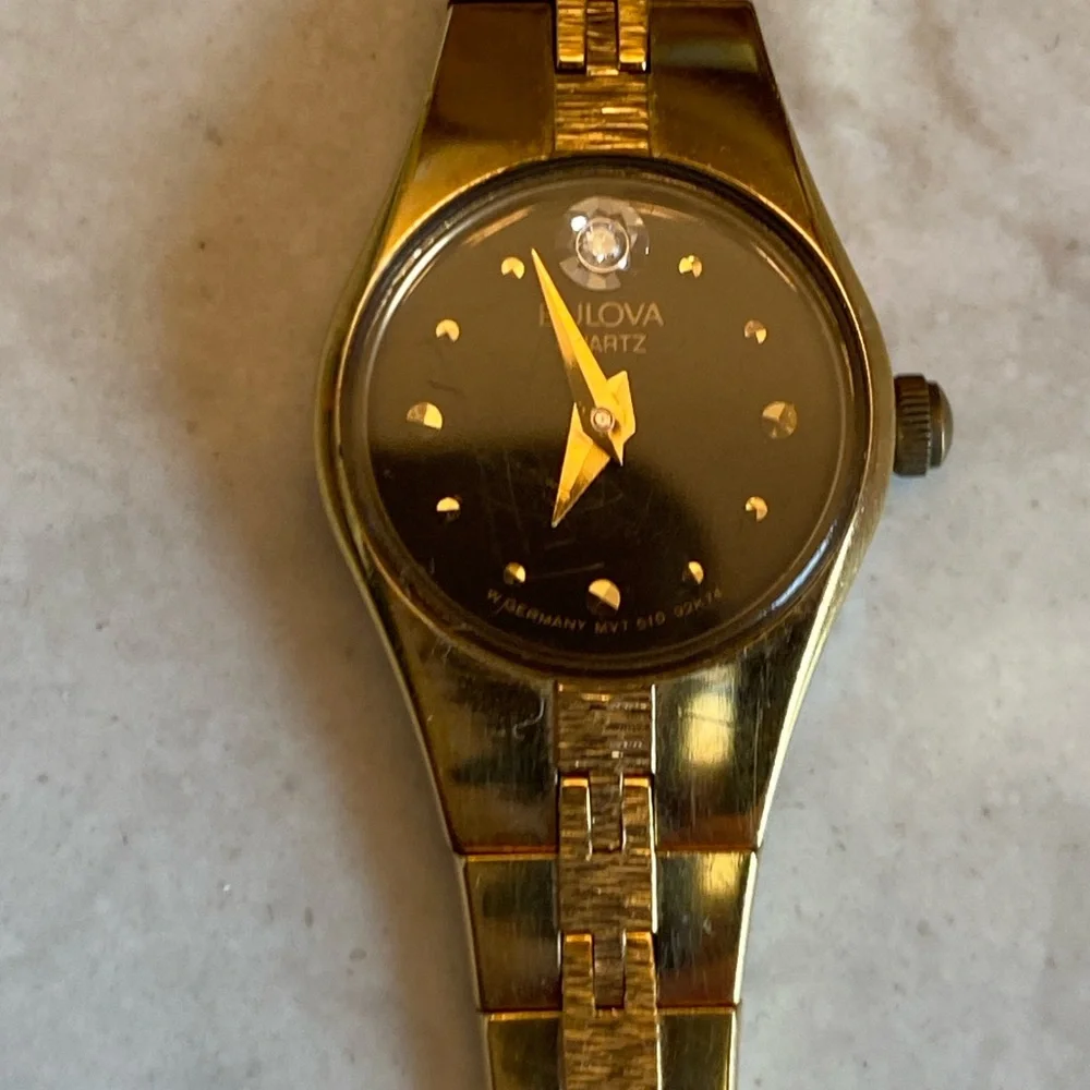 Bulova 14 k Gold filled, Quartz with Black face and small Diamond. France stamp.